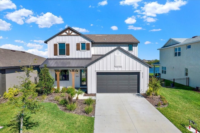 modern inspired farmhouse featuring a front yard, fence, driveway, a garage, and board and batten siding