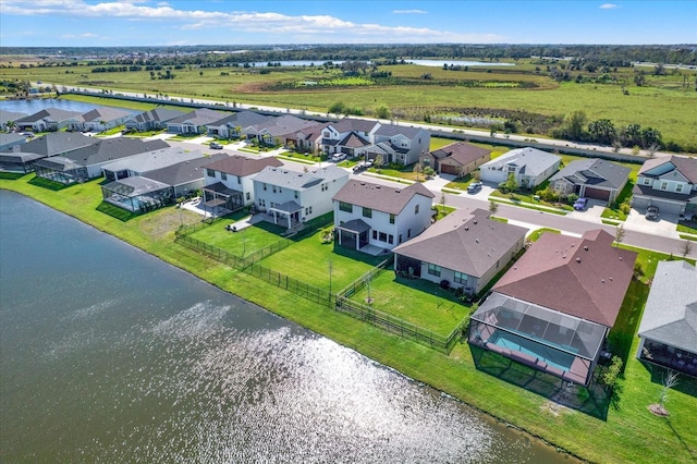 drone / aerial view with a residential view and a water view