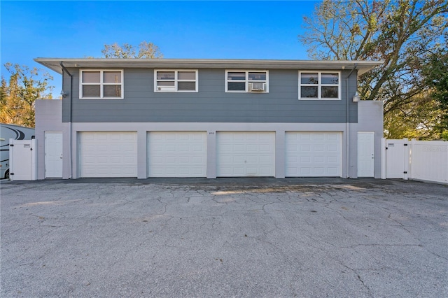 garage with a gate and fence