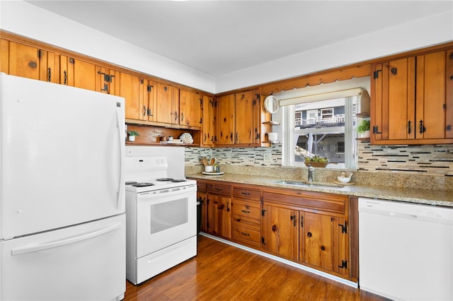 kitchen with white appliances, dark wood-style flooring, a sink, brown cabinets, and open shelves