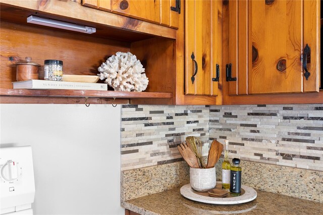 details with tasteful backsplash and brown cabinets