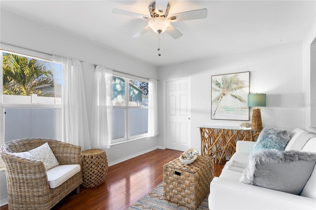 interior space with hardwood / wood-style flooring, baseboards, and a ceiling fan