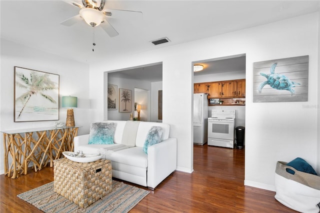 living area with ceiling fan, dark wood-style flooring, visible vents, and baseboards