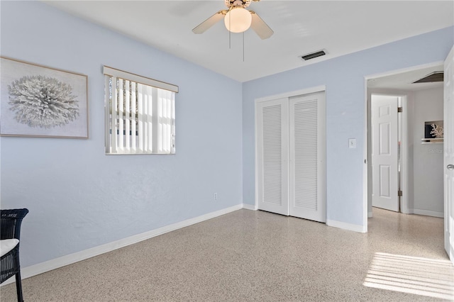 bedroom featuring a closet, visible vents, baseboards, and speckled floor