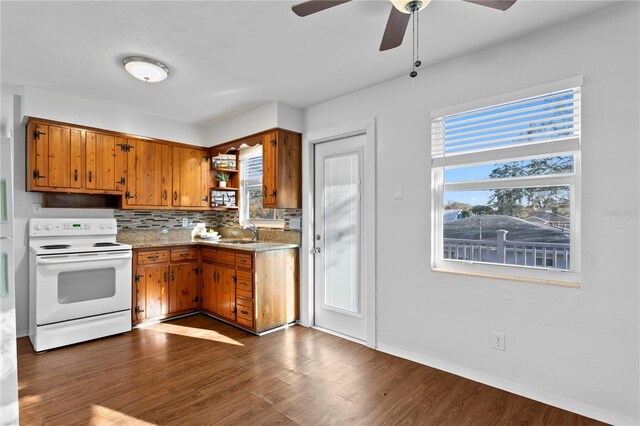 kitchen featuring a sink, white range with electric stovetop, open shelves, brown cabinetry, and dark wood finished floors