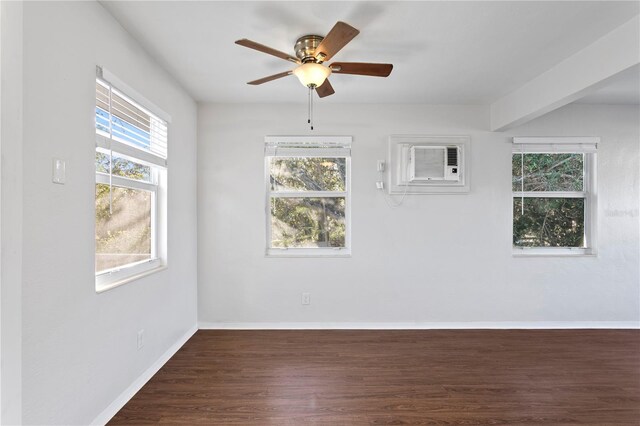 empty room featuring a ceiling fan, wood finished floors, baseboards, and a wall mounted AC