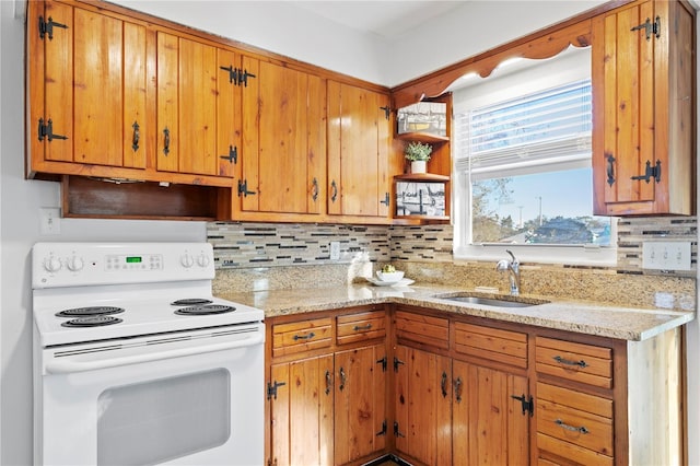 kitchen with open shelves, white electric range, backsplash, brown cabinetry, and a sink