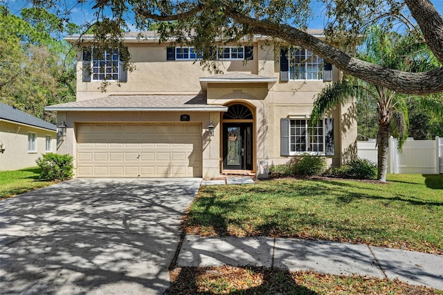 view of front of home featuring a garage, fence, driveway, stucco siding, and a front lawn