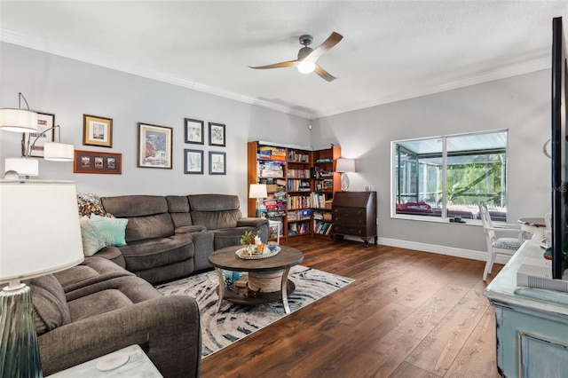 living area featuring ceiling fan, ornamental molding, hardwood / wood-style flooring, and baseboards