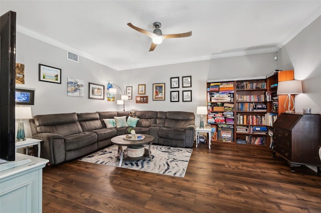 living area with ceiling fan, wood finished floors, visible vents, and crown molding