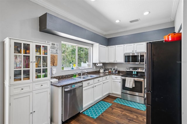 kitchen with visible vents, appliances with stainless steel finishes, white cabinets, and a sink