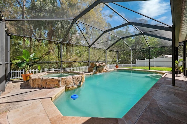 view of swimming pool with a fenced backyard, a pool with connected hot tub, and a patio