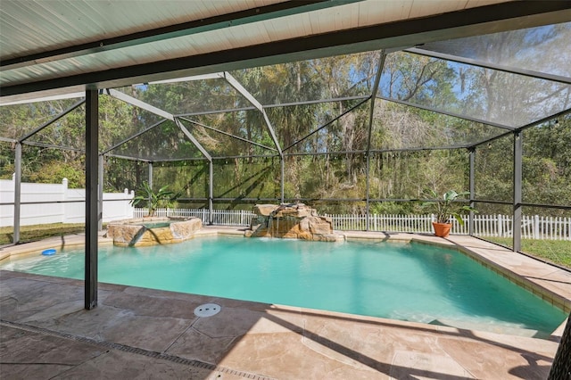 view of pool with a pool with connected hot tub, a lanai, a fenced backyard, and a patio