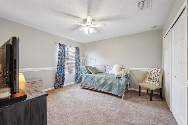 bedroom featuring carpet, a closet, visible vents, a ceiling fan, and baseboards