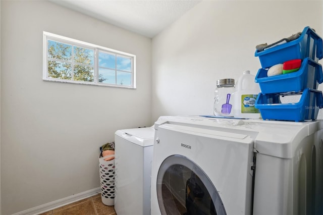 laundry room featuring laundry area, washer and clothes dryer, baseboards, and tile patterned floors