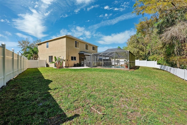 view of yard featuring a lanai, a patio area, and a fenced backyard