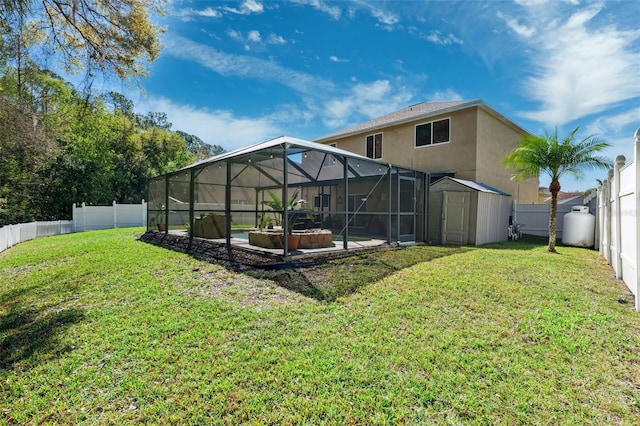 rear view of property with glass enclosure, a shed, a fenced backyard, and stucco siding