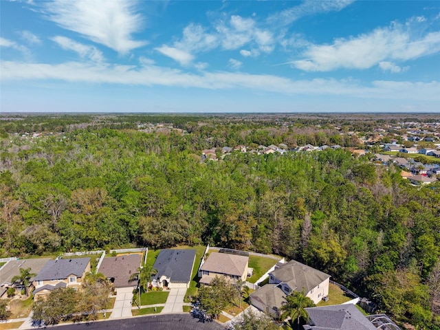 birds eye view of property featuring a forest view and a residential view