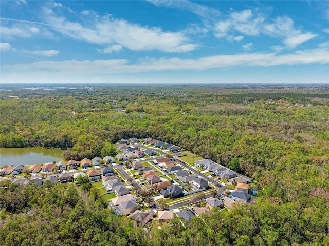 birds eye view of property featuring a water view, a forest view, and a residential view