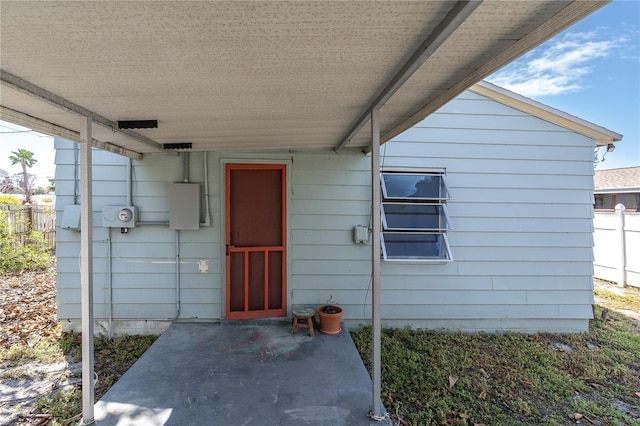 doorway to property featuring a patio area and fence