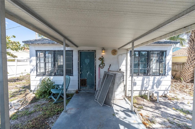 doorway to property featuring fence and a patio