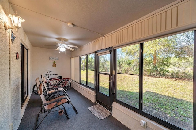 sunroom / solarium featuring ceiling fan