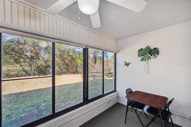 sunroom / solarium featuring ceiling fan