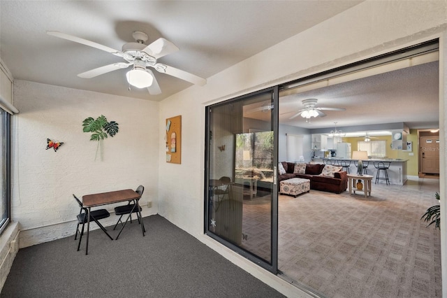 sunroom with ceiling fan with notable chandelier