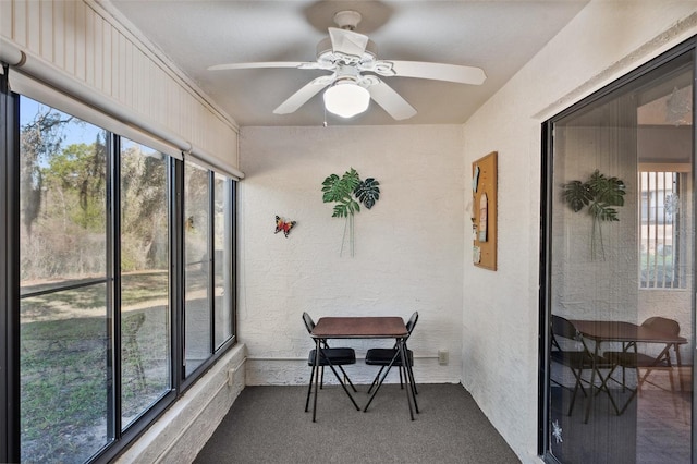 sunroom featuring a ceiling fan