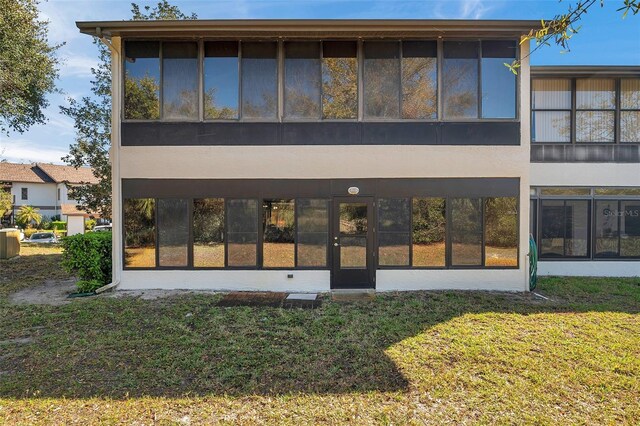 rear view of property with a lawn