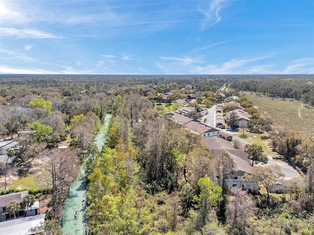 birds eye view of property with a wooded view