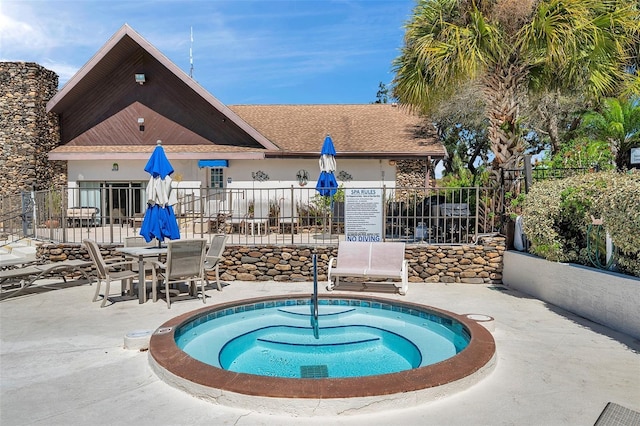 view of pool with a patio and fence