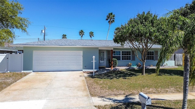 single story home featuring concrete driveway, an attached garage, fence, a front lawn, and brick siding