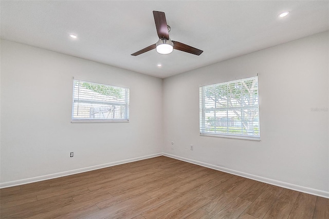 unfurnished room with ceiling fan, recessed lighting, wood finished floors, and baseboards