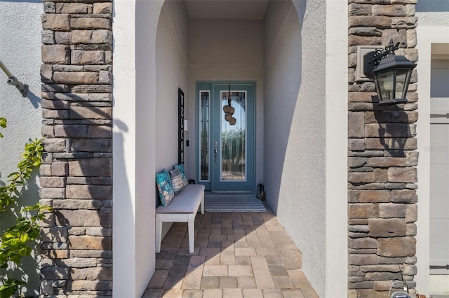 entrance to property featuring stucco siding