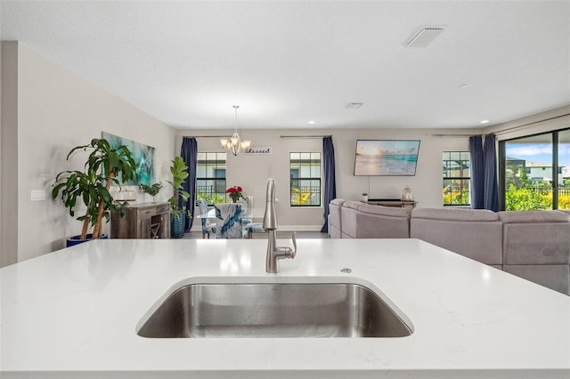 kitchen featuring open floor plan, visible vents, a sink, and a healthy amount of sunlight