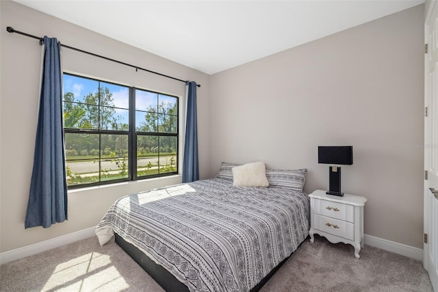 carpeted bedroom featuring baseboards