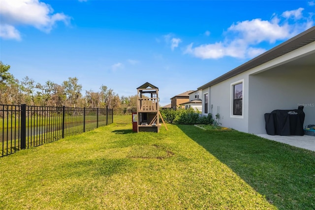 view of yard featuring a playground and a fenced backyard