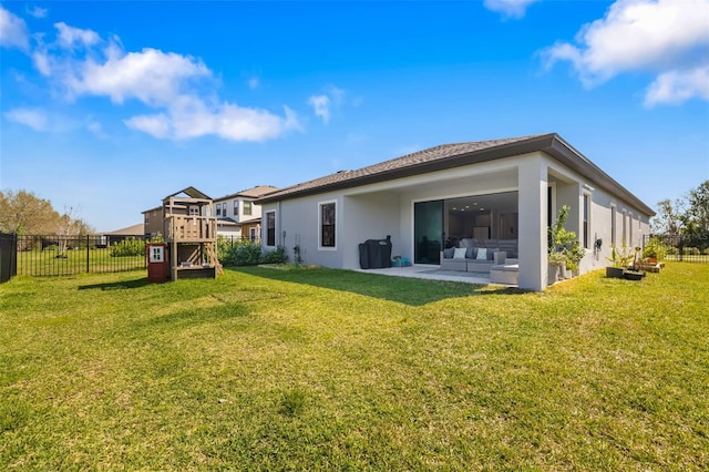 rear view of house featuring a patio, a fenced backyard, a yard, an outdoor living space, and stucco siding