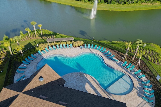 pool featuring a patio area and a water view