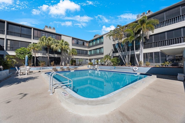 community pool with a patio area