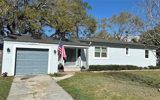 ranch-style home featuring driveway, a front yard, an attached garage, and stucco siding