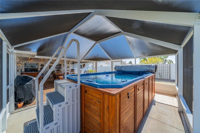 view of patio / terrace with a lanai, a grill, and fence