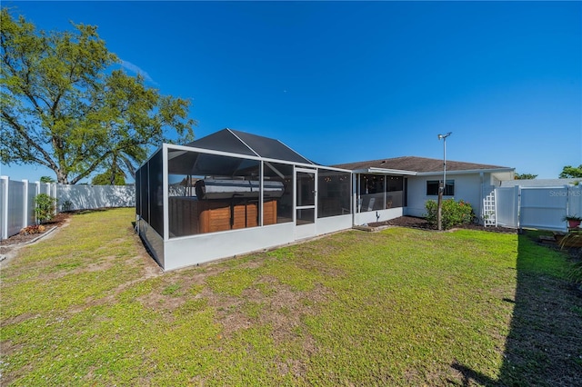 back of property featuring a yard, a fenced backyard, and a gate