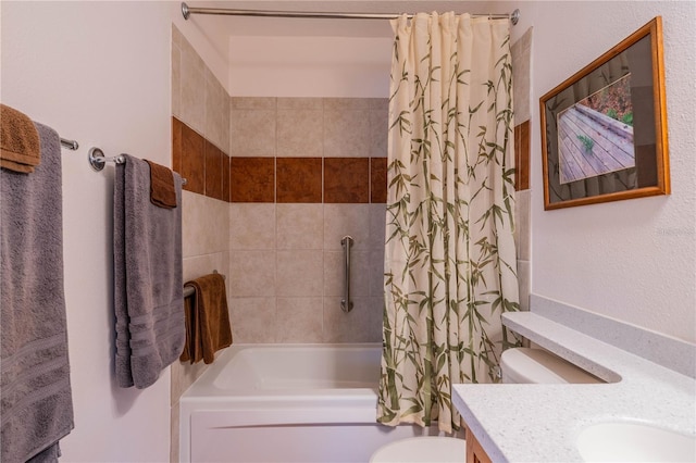 full bathroom featuring shower / bath combo, vanity, and toilet