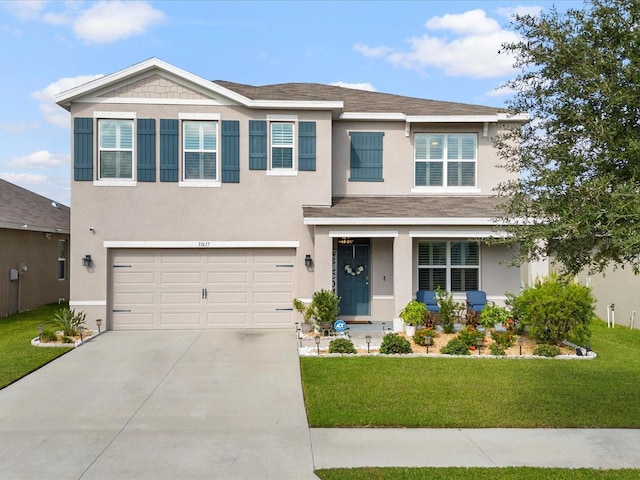 view of front of house featuring driveway, a garage, stucco siding, covered porch, and a front yard