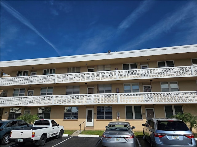 view of property featuring uncovered parking