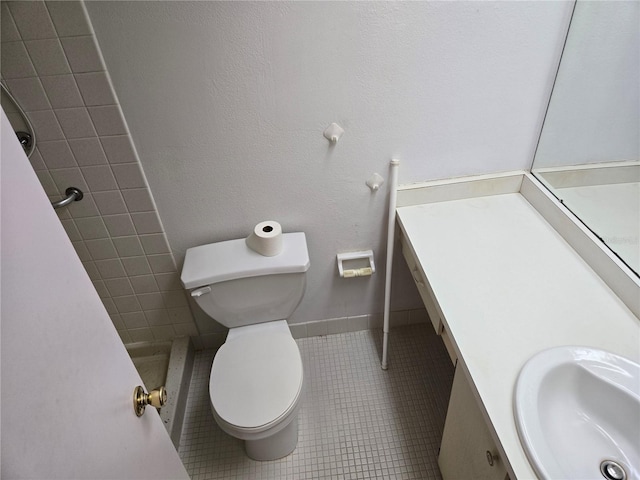 full bath with tile patterned flooring, toilet, vanity, and baseboards