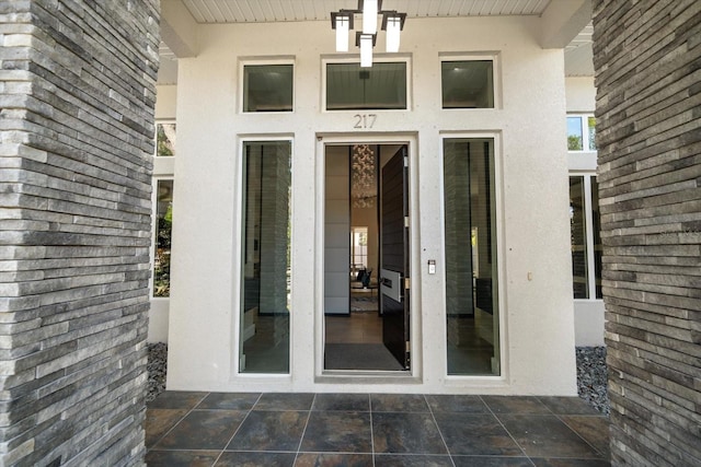 doorway to property featuring stucco siding