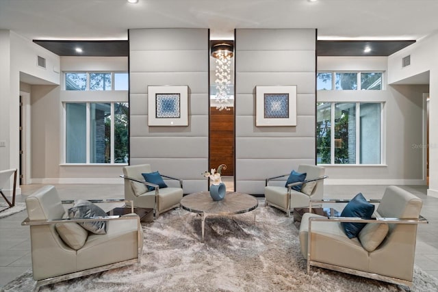 living area featuring tile patterned flooring, visible vents, recessed lighting, and baseboards